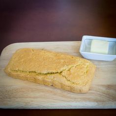 a loaf of bread sitting on top of a wooden cutting board