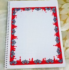 a notebook with red and grey paint splattered on it