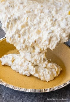 a bowl filled with cream cheese sitting on top of a table