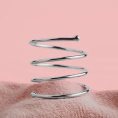 If you are looking for a unique and stylish ring that will get you noticed, then look no further than this Adjustable Sterling Silver Spiral Bypass Ring. This ring is handmade from solid Sterling Silver and shined to a mirror finish, giving it a luxurious look and feel. The minimalist design of this ring makes it perfect for everyday wear, but it is also unique enough to be worn as a statement piece. Whether you are treating yourself or buying a gift for someone else, this Adjustable Sterling Si Wrap Around Ring, Coil Ring, Bypass Ring, Midi Ring, Stylish Rings, Midi Rings, The Minimalist, A Mirror, Minimalist Design