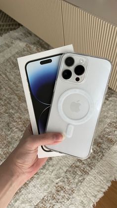 someone holding an iphone 11 in their hand with the box open and it's empty