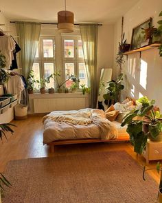 a bed room with a neatly made bed and lots of plants