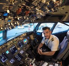 a man sitting in the cockpit of an airplane