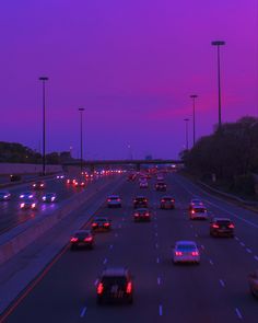 cars are driving down the highway at night