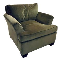 a green chair with a brown pillow on it's back and armrests