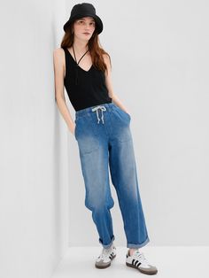 Fit: Pull-on jeans with an elastic waistband & easy, relaxed leg.  Fabric: 95% Cotton, 5% Recycled Cotton.  Stretch: No Stretch Jeans.  Authentic denim that gets better with every wear.  Made to wear all day & break in over time. ​ Rise: Mid Rise Jeans.  Look: A four-pocket jean in a medium indigo wash with fading.  Raw, cuffed hem can be unrolled.  Details: Elasticized waist with drawcords & four-pocket styling.  Responsibly Made: This pair of jeans is part of our water-saving Washwell program. Pull On Jeans, Water Saving, Jeans Mom, Break In, Gap Jeans, Mid Rise Jeans, Pocket Jeans, High Rise Jeans, Recycled Cotton