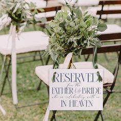 a sign that says reserved to the bride and groom is sitting in front of some chairs