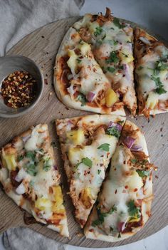 four slices of pizza on a wooden board