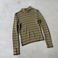 vintage 90s green and brown striped turtleneck sweater. lightweight.  Label: world LOB clothing 2 Size: (label size M) best for modern small or medium depending on desired fit, refer to measurements for detailed size info Model is a medium / size 8 Excellent Vintage Condition  MEASUREMENTS IN INCHES (laid flat double where needed) : very stretchy PIT TO PIT: 15.5 / WAIST: 13.5 / LENGTH: 21 Each vintage piece has been preloved. Minor fading + wear is expected & often adds to the character. All items are cleaned & from a smoke & pet free building. We hope you appreciate this find as much as we do. Brown Striped Sweater, Striped Turtleneck Sweater, Daily Clothes, Long Sleeve Jumper, Womens Sweaters, Striped Turtleneck, Size Label, Striped Sweater, Denim Mini Skirt