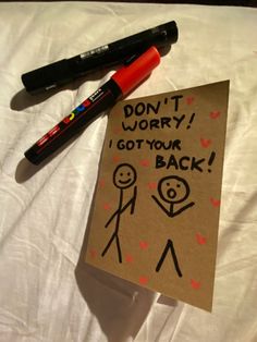 a note that says don't worry i got your back on top of a bed