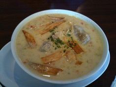 a white bowl filled with soup on top of a table