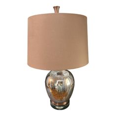 a glass lamp with a brown shade on it's base and a beige lampshade