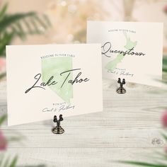 two cards with the name and map of lake tahoe in black ink on them