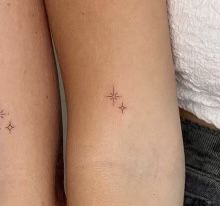 two people with small tattoos on their arms