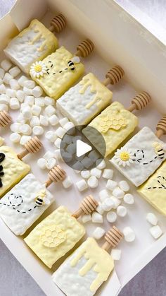 a box filled with lots of different types of cakes on top of a white table