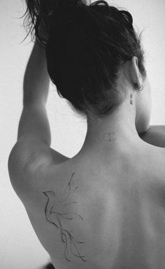 a woman with a tattoo on her back