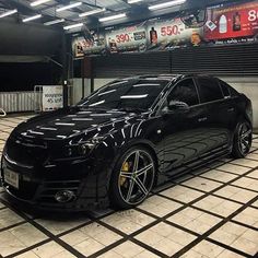 a black sports car parked in a garage