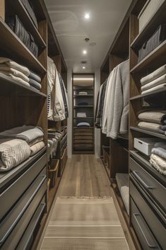 a walk - in closet with lots of folded clothes and linens on the shelves