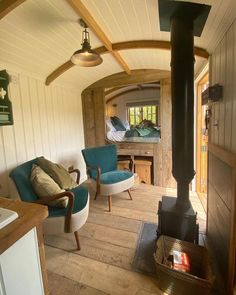 a living room filled with furniture and a fire place in the middle of a room