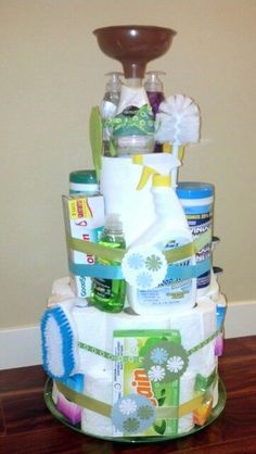 a multi layer diaper cake sitting on top of a hard wood floor next to a wall