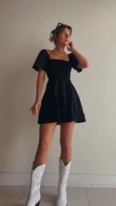 Dress With Cowboy Boots Concert, Black Dress And White Boots, Black Dress For Concert, Slip Dress With Cowgirl Boots, All Black Cowboy Boots Outfit, Cute Cowgirl Dress Outfits, Fall Wedding Guest Dress Cowboy Boots, Colored Cowboy Boots Outfit, Cowboy Dress Outfit