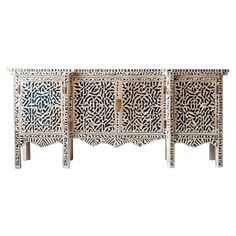 an intricately carved sideboard with three doors