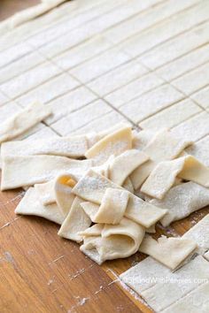 uncooked ravioli on a wooden cutting board