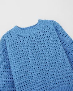 a blue knitted sweater on a white background