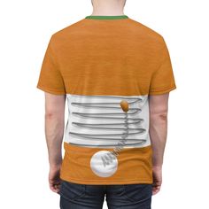 the back of a man wearing an orange t - shirt with white circles on it