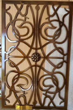 an ornate metal door with decorative designs on it