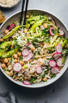 a bowl filled with broccoli, radishes and chickpea salad