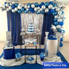 a blue and silver themed party with balloons