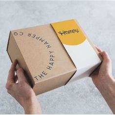 a person holding a box with the word happy written on it