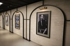 an empty hallway with posters on the wall