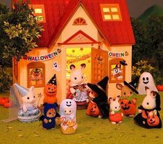 a group of stuffed animals in front of a halloween house