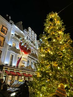 a large christmas tree in front of a building