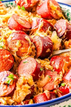 a bowl filled with sausage and rice on top of a table