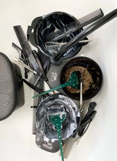 a table topped with lots of different types of hair brushes