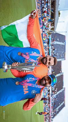 two men standing next to each other on a field with flags in front of them