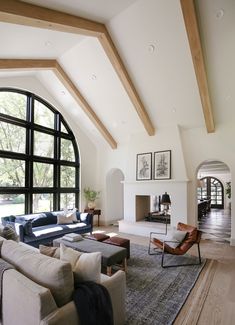 a living room with large windows and lots of furniture