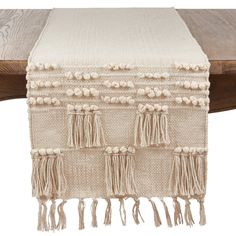 a table runner with tassels on it