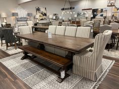 a large dining room table and chairs in a store