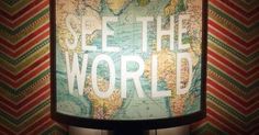 a lamp with the words see the world on it in front of a chevron background