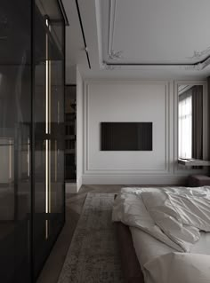 an empty bedroom with a large white bed and black wardrobes in the corner next to it