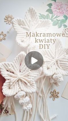 the video is showing how to make an intricate flower decoration with yarn and buttons on it