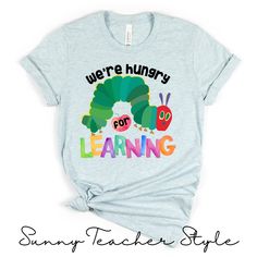 We're Hungry for Learning ~ Teacher Shirt 🔆FEATURES: * 100% Airlume combed and ringspun cotton * Light Weight: 4.2 oz. * Relaxed Fit * Tear Away Label * Dual Side Seams * Taped Shoulders for better fit * Runs true to Size 🔆UNISEX SIZING: Please refer to size chart 🔆CARE INSTRUCTIONS: - Wash colors separately - Tumble dry on slow setting - Iron on low heat on reverse side to print - Do NOT iron print - Do not dry clean - Do not bleach 🔆This shirt is MADE TO ORDER.  🔆PRODUCTION: 1 - 4 days We Early Childhood Teacher Shirts, Kindergarten Teacher Tshirt Ideas, Cute Preschool Teacher Shirts, Hungry Caterpillar Teacher Shirts, Preschool Teacher Tshirts, Preschool Teacher Shirts Designs, Preschool T Shirts, Infant Teacher Shirts, Teacher Graphic Tees