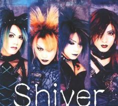 four women with punk hair and piercings are posing in front of an advertisement for silver