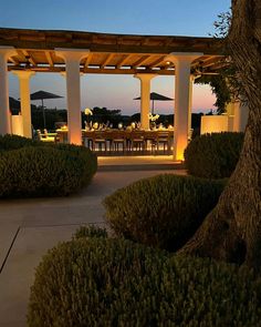 an outdoor dining area is lit up at night