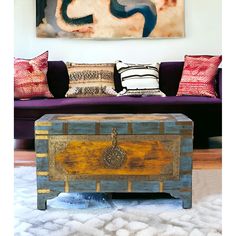 a living room filled with furniture and a painting on the wall