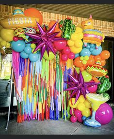 an assortment of balloons and streamers on display